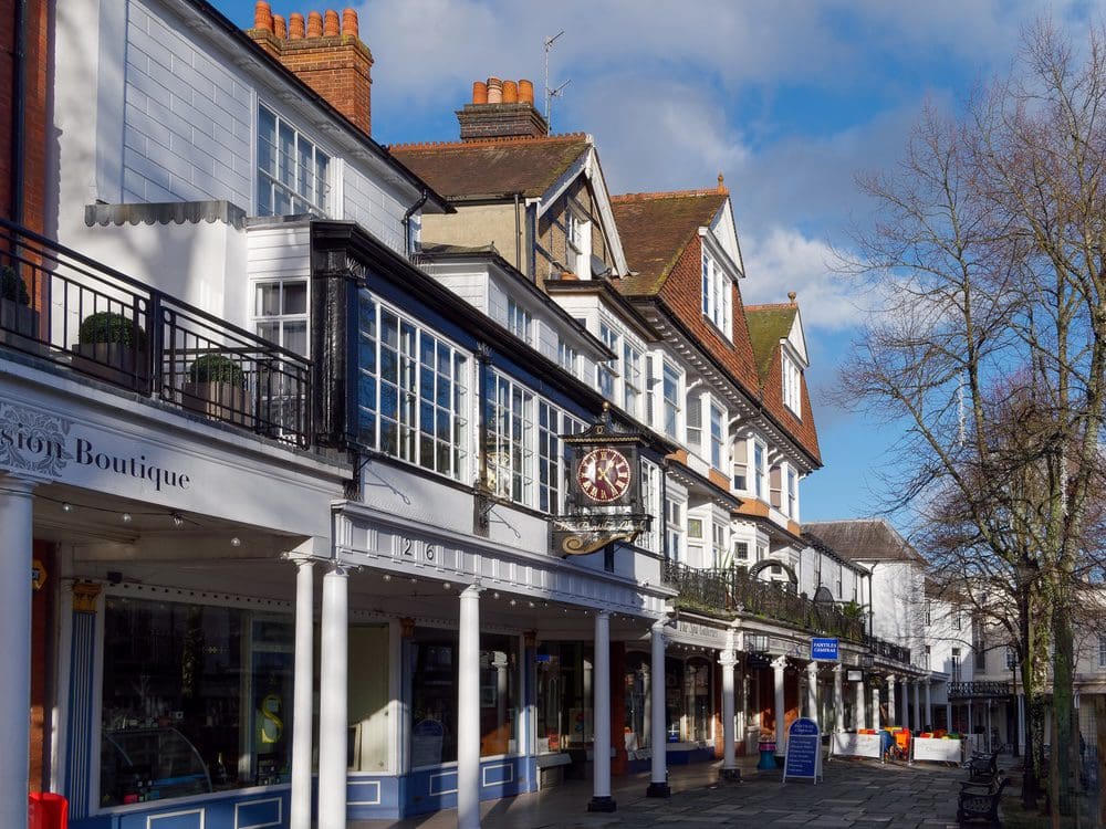 Historic street with shops under blue sky.