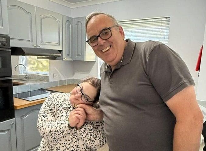 Tenant Victoria and Housing Manager Allan in Victoria's kitchen.